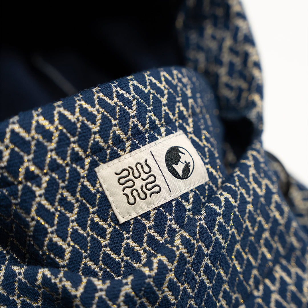 NOMADIK（ノマディック）| 777 JACQUARD HOODWARMER 2026 / BLUE/BEIGE